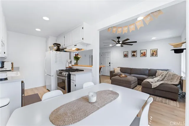 a living room with furniture and kitchen view