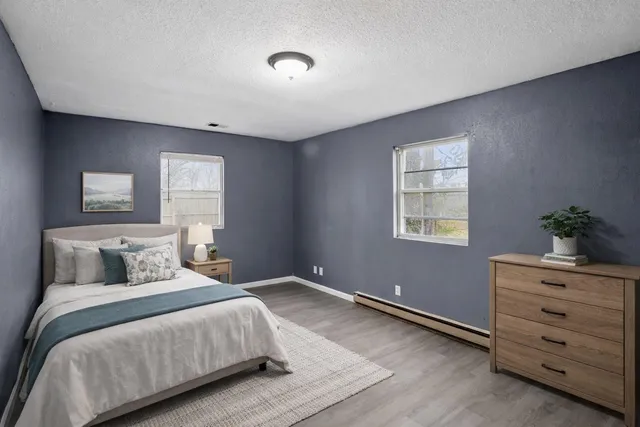 a bedroom with a bed and a potted plant