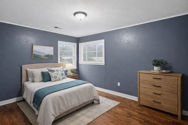 a bedroom with a bed and a dresser