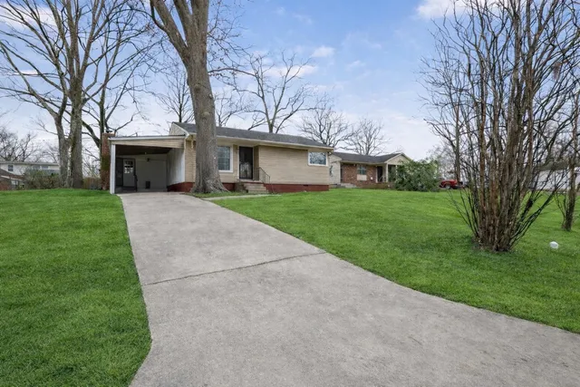 a backyard of a house with table and chairs