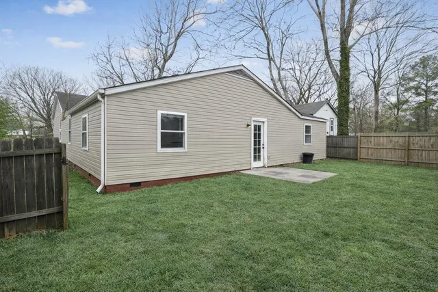 a view of a house with a yard and garage