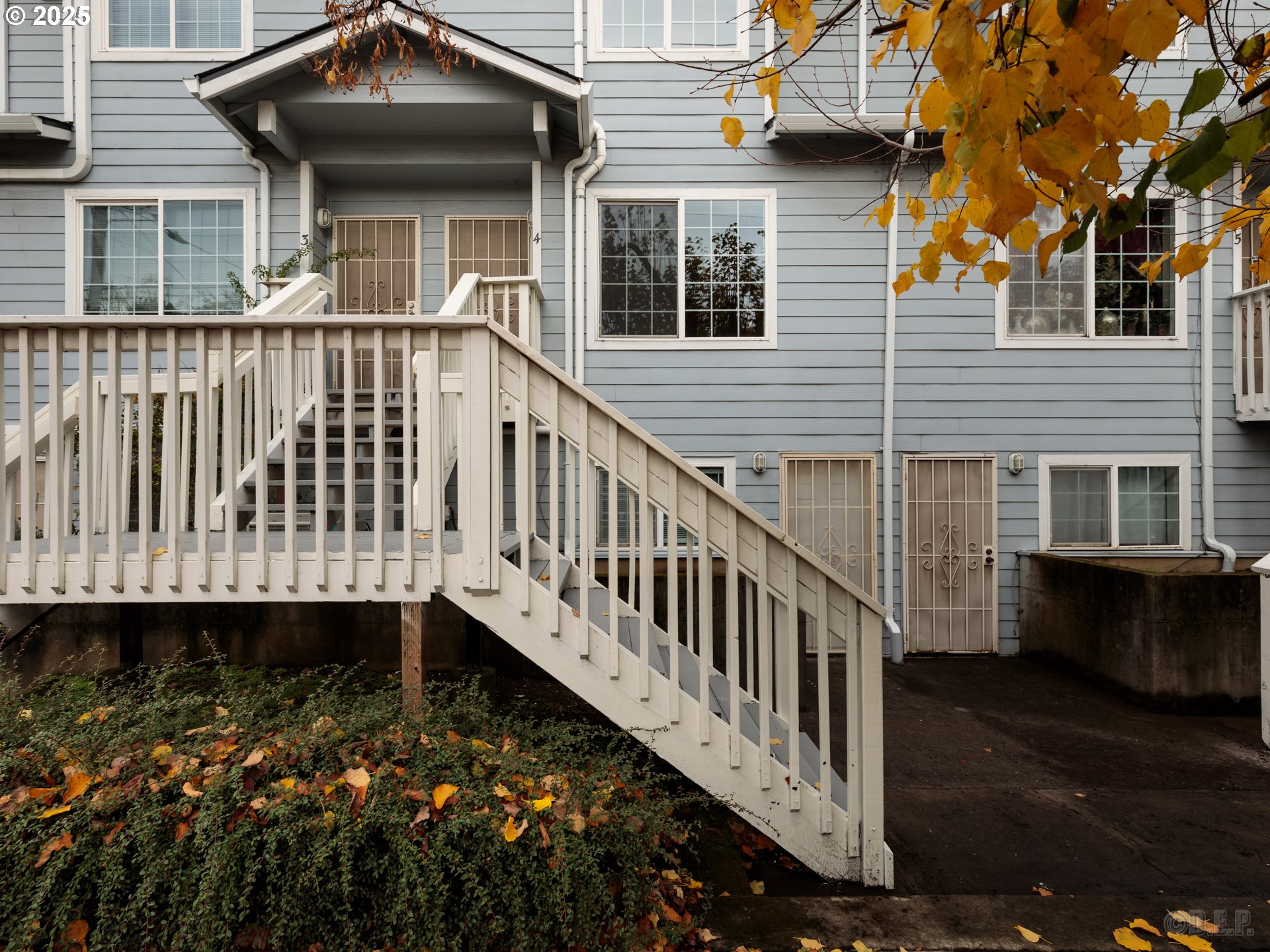 6621 North Columbia Way, Unit 4 Portland, OR 97203 - Photo 2 of 22 a view of a house with wooden deck and a floor to ceiling window