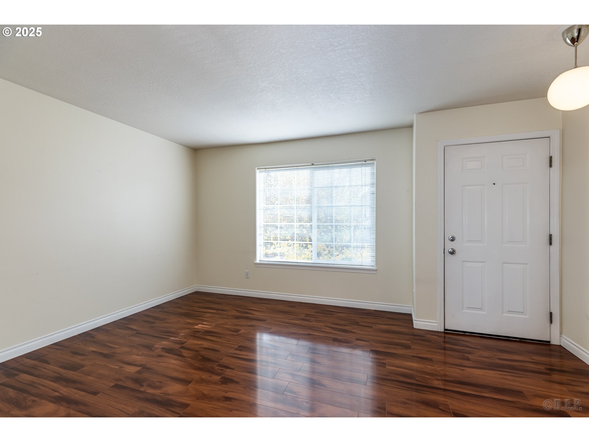 6621 North Columbia Way, Unit 4 Portland, OR 97203 - Photo 4 of 22 a view of an empty room with wooden floor and a window