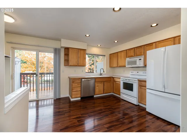 a kitchen with a refrigerator and a stove top oven