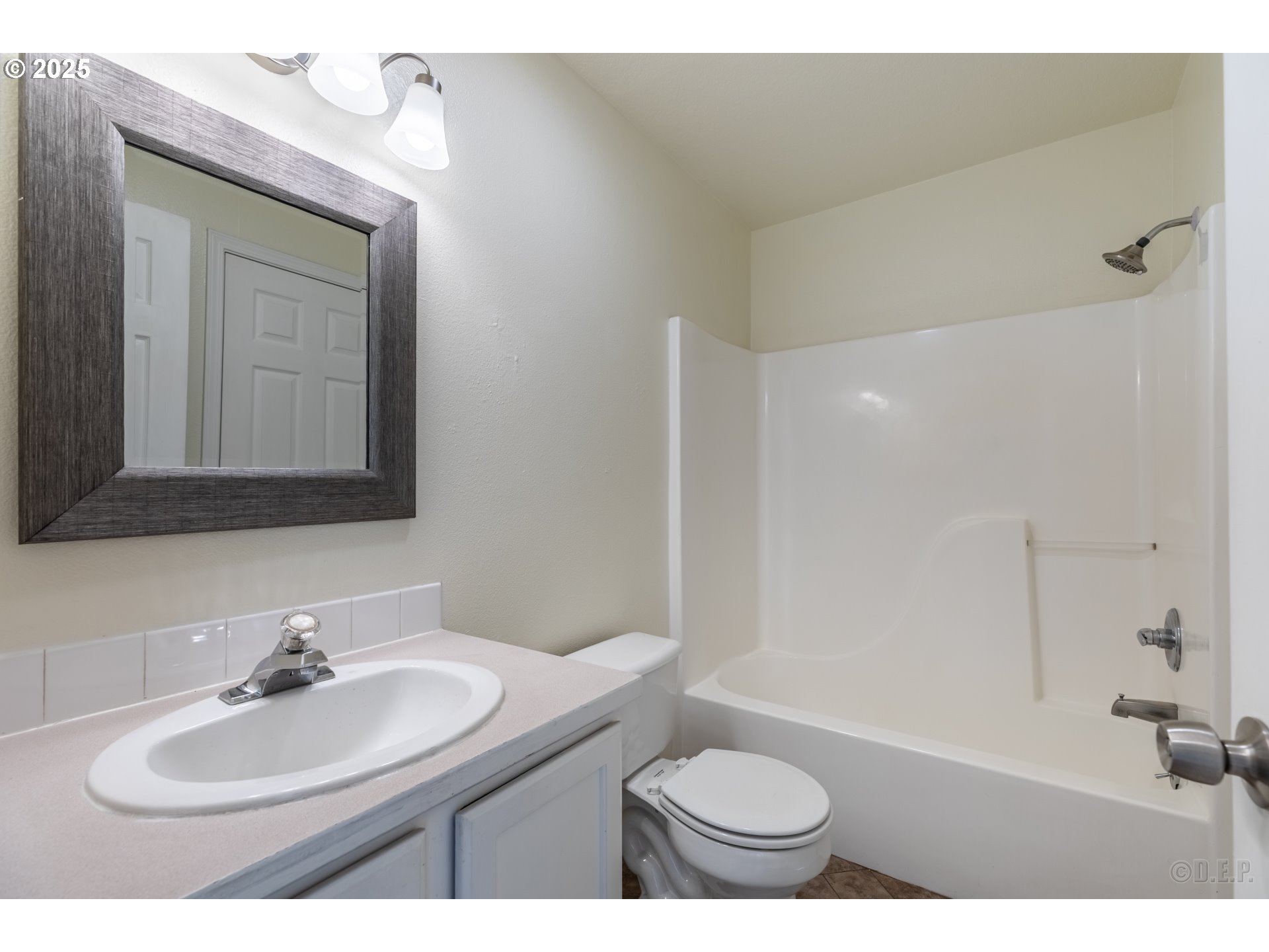 6621 North Columbia Way, Unit 4 Portland, OR 97203 - Photo 10 of 22 a bathroom with a sink a toilet and a mirror