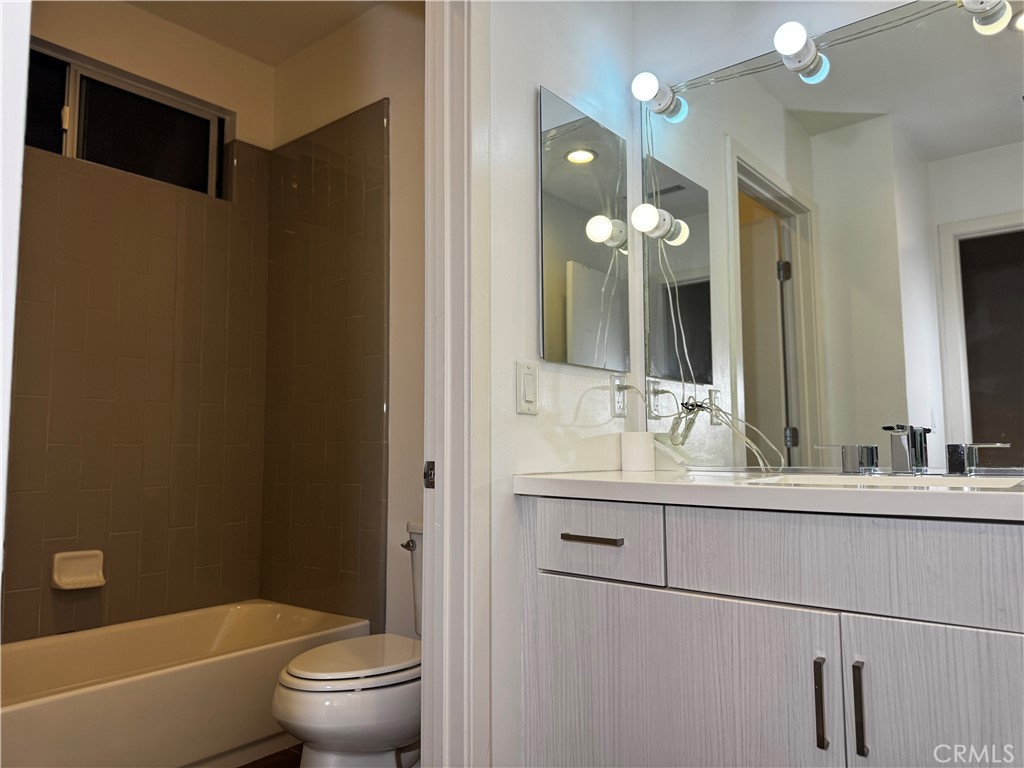2205 Tom Mix Road Los Angeles, CA 90026 - Photo 14 of 20 a bathroom with a double vanity sink mirror toilet and bathtub