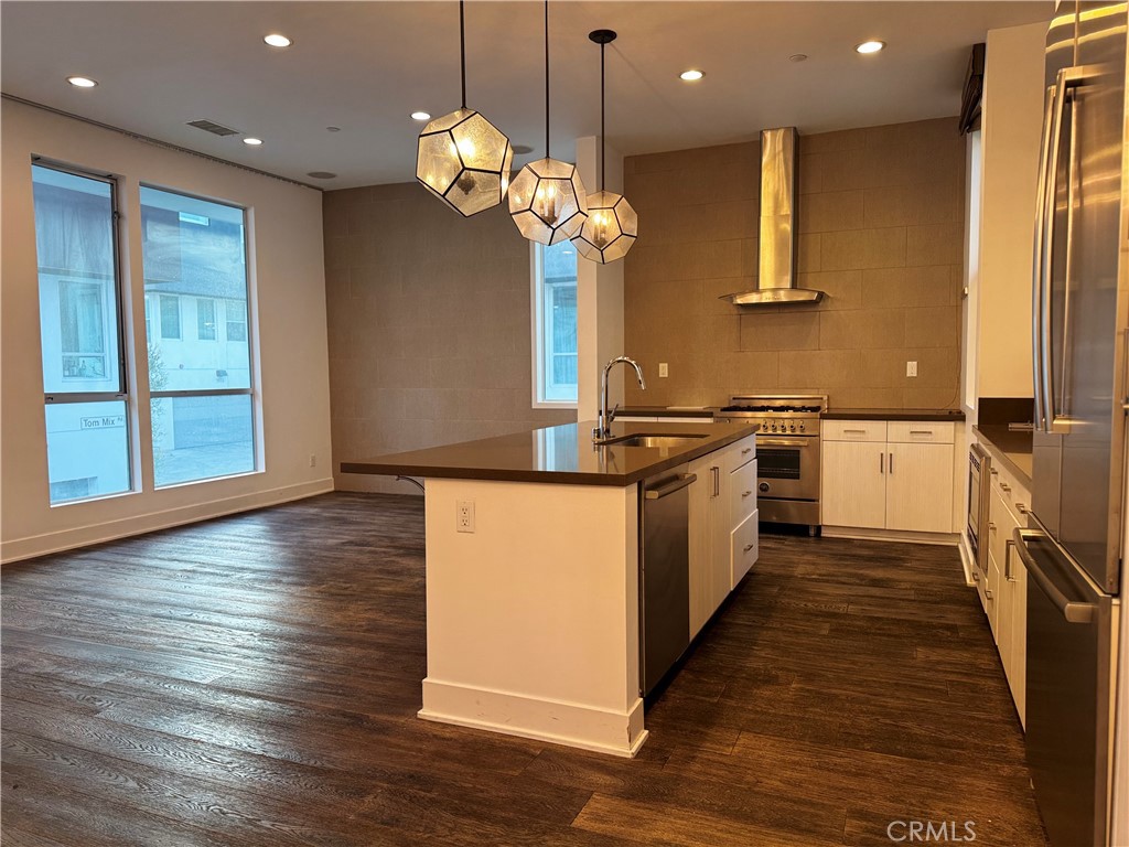 2205 Tom Mix Road Los Angeles, CA 90026 - Photo 4 of 20 a kitchen with stainless steel appliances granite countertop a sink a stove and a wooden floors