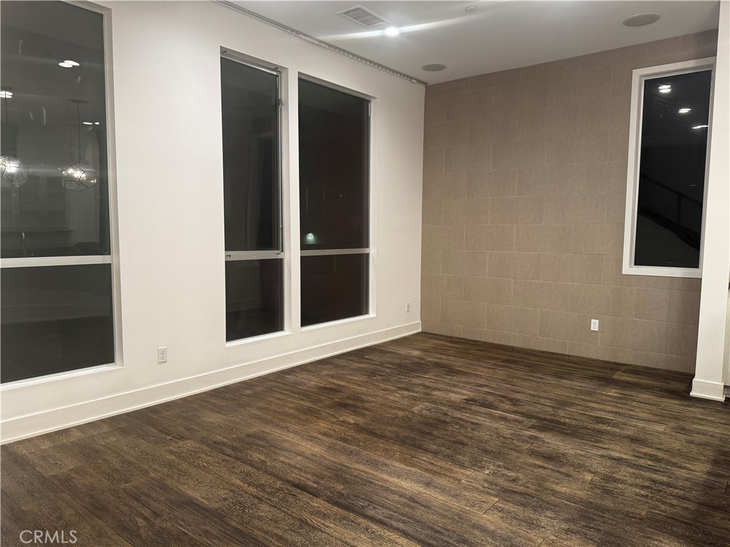 2205 Tom Mix Road Los Angeles, CA 90026 - Photo 5 of 20 an empty room with wooden floor and windows