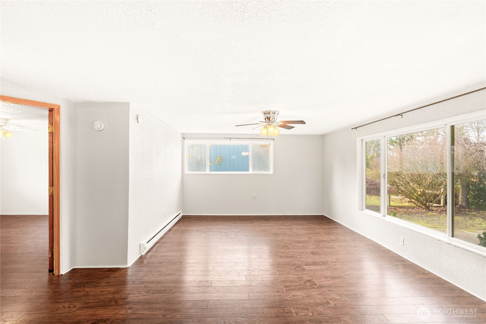 504 South 6th Street McCleary, WA 98557 - Photo 20 of 40 an empty room with wooden floor and windows