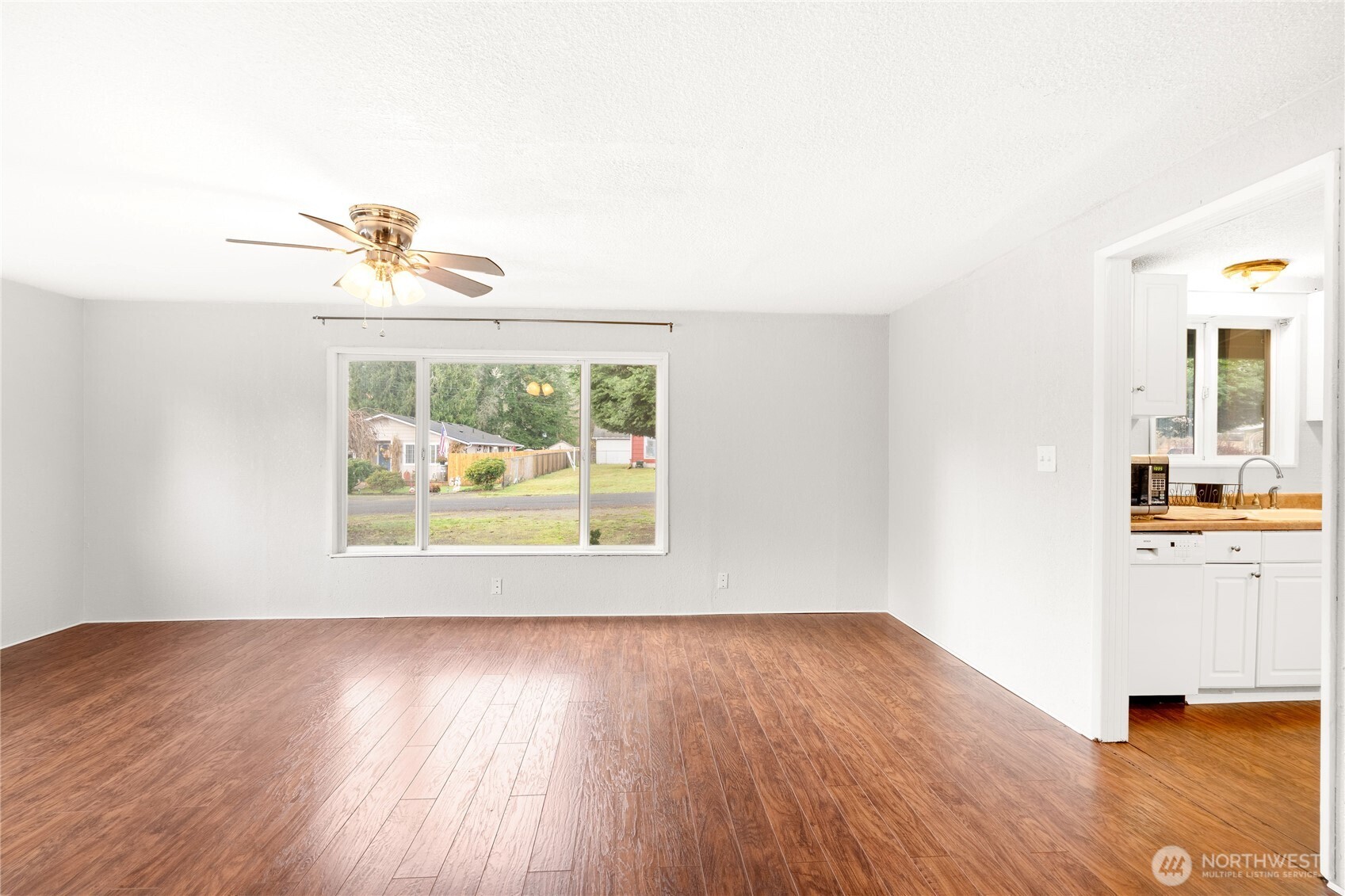 504 South 6th Street McCleary, WA 98557 - Photo 21 of 40 a view of an empty room with a window and wooden floor