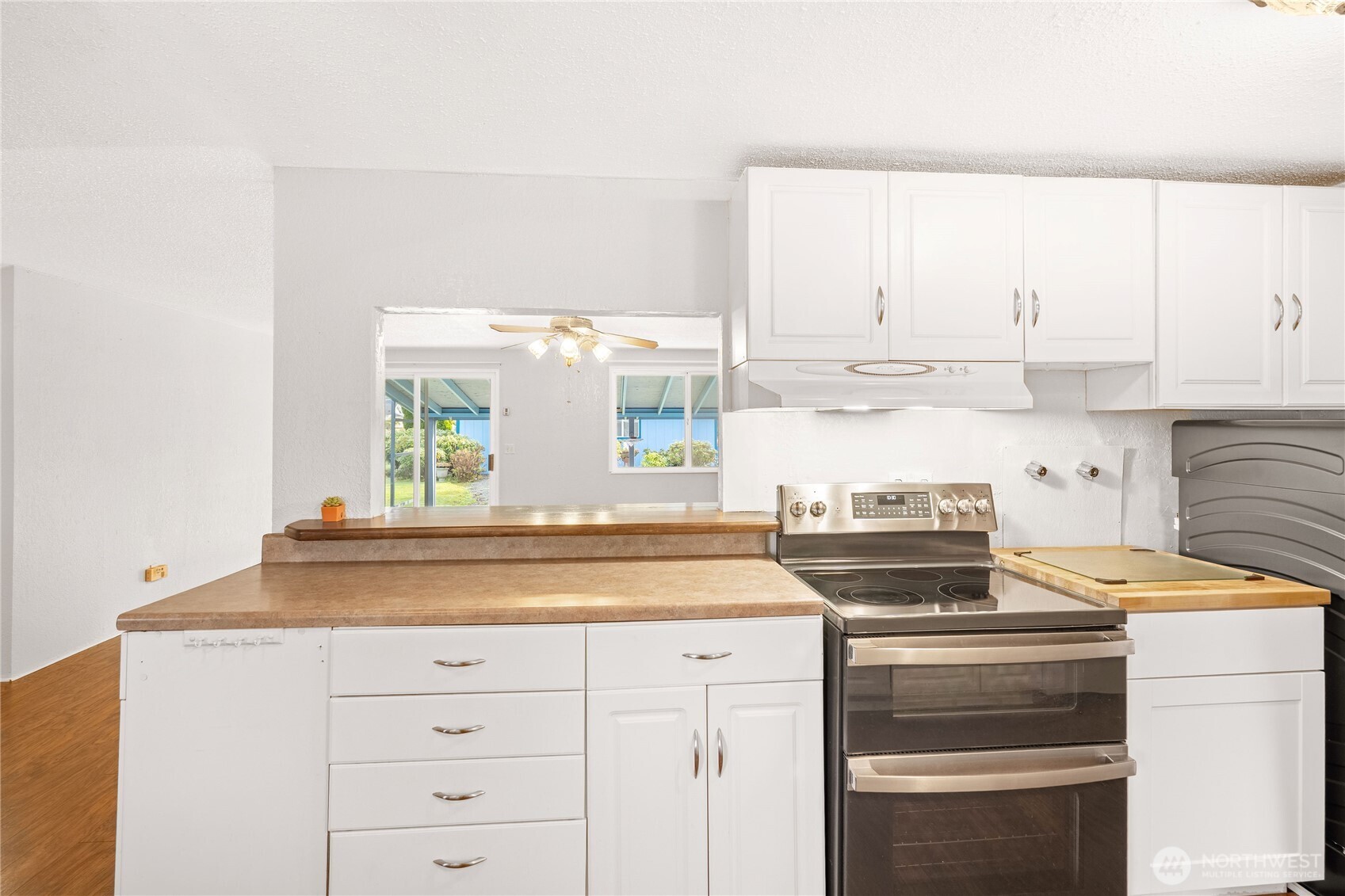504 South 6th Street McCleary, WA 98557 - Photo 7 of 40 a kitchen with granite countertop a stove and a sink