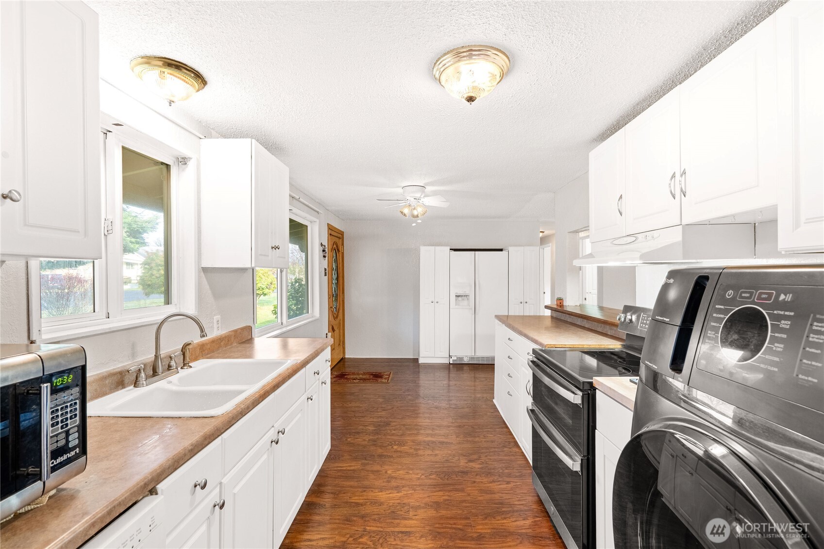 504 South 6th Street McCleary, WA 98557 - Photo 8 of 40 a view of a kitchen with kitchen island a sink a stove and a window