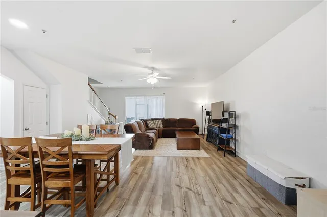 a view of a dining room with furniture and wooden floor