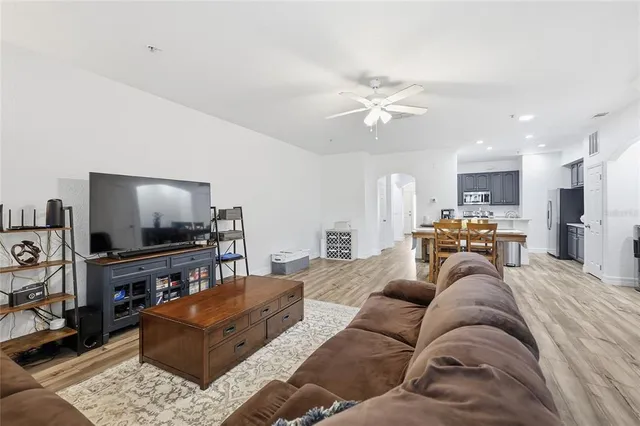 a spacious bedroom with a bed a window and dresser