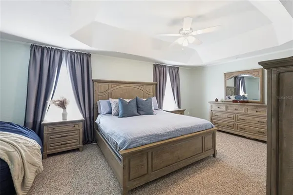 a bedroom with a bed next to a window