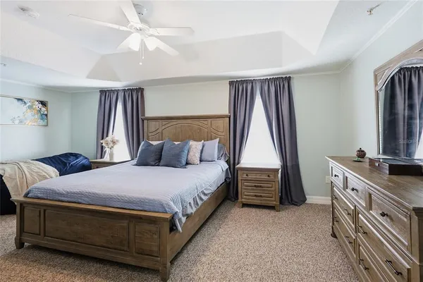 a bedroom with a large bed and a flat screen tv