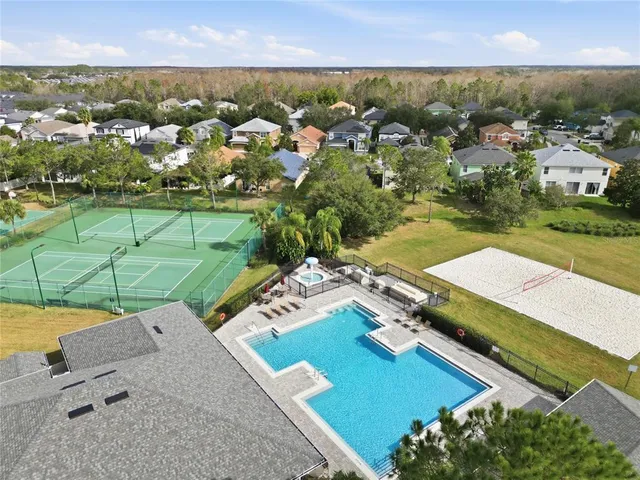 an aerial view of residential houses with outdoor space and swimming pool
