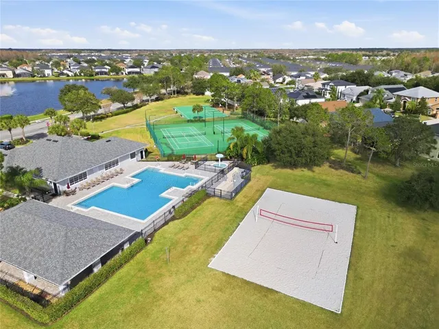 a swimming pool with outdoor seating and plants