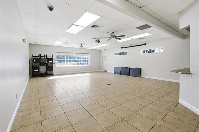 a view of a livingroom with furniture and chandelier fan