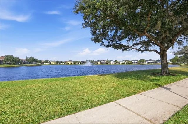 an aerial view of residential houses with outdoor space and ocean view