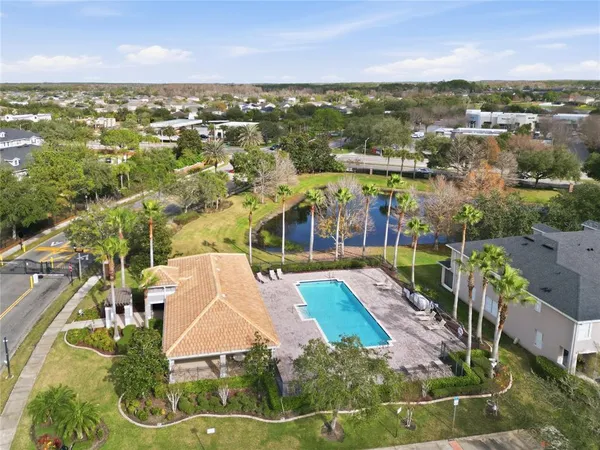an aerial view of a house with a garden and swimming pool