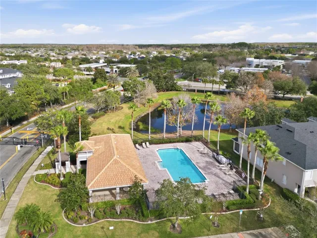 an aerial view of a house with a garden and swimming pool