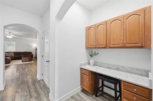a kitchen with a refrigerator and a stove top oven