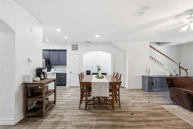 a living room with lots of furniture and a wooden floor