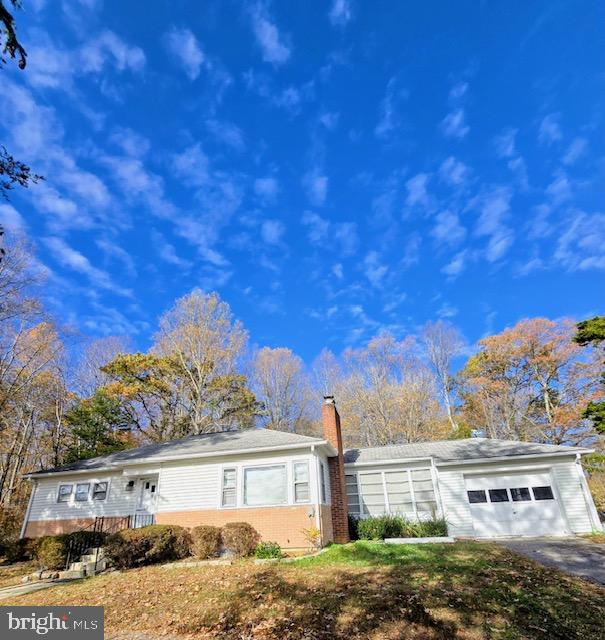 7032 Token Valley Road Manassas, VA 20112 - Photo 3 of 25 a front view of a house with a yard