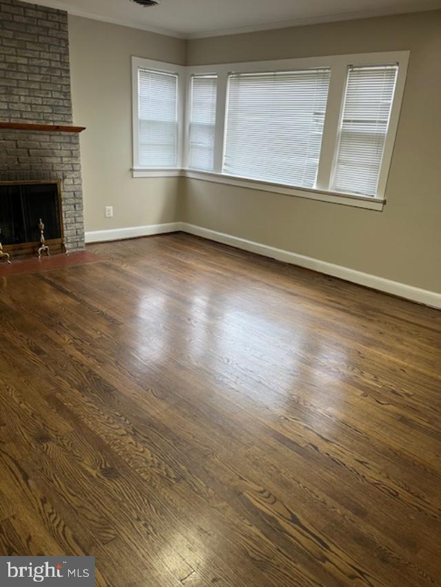 7032 Token Valley Road Manassas, VA 20112 - Photo 4 of 25 a view of an empty room with wooden floor and a window