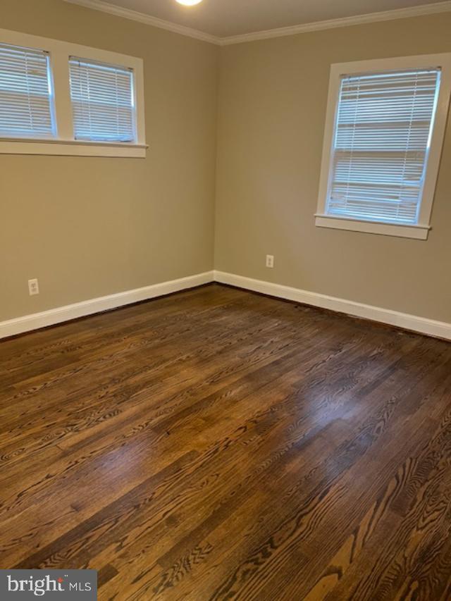 7032 Token Valley Road Manassas, VA 20112 - Photo 7 of 25 a view of an empty room with wooden floor and a window
