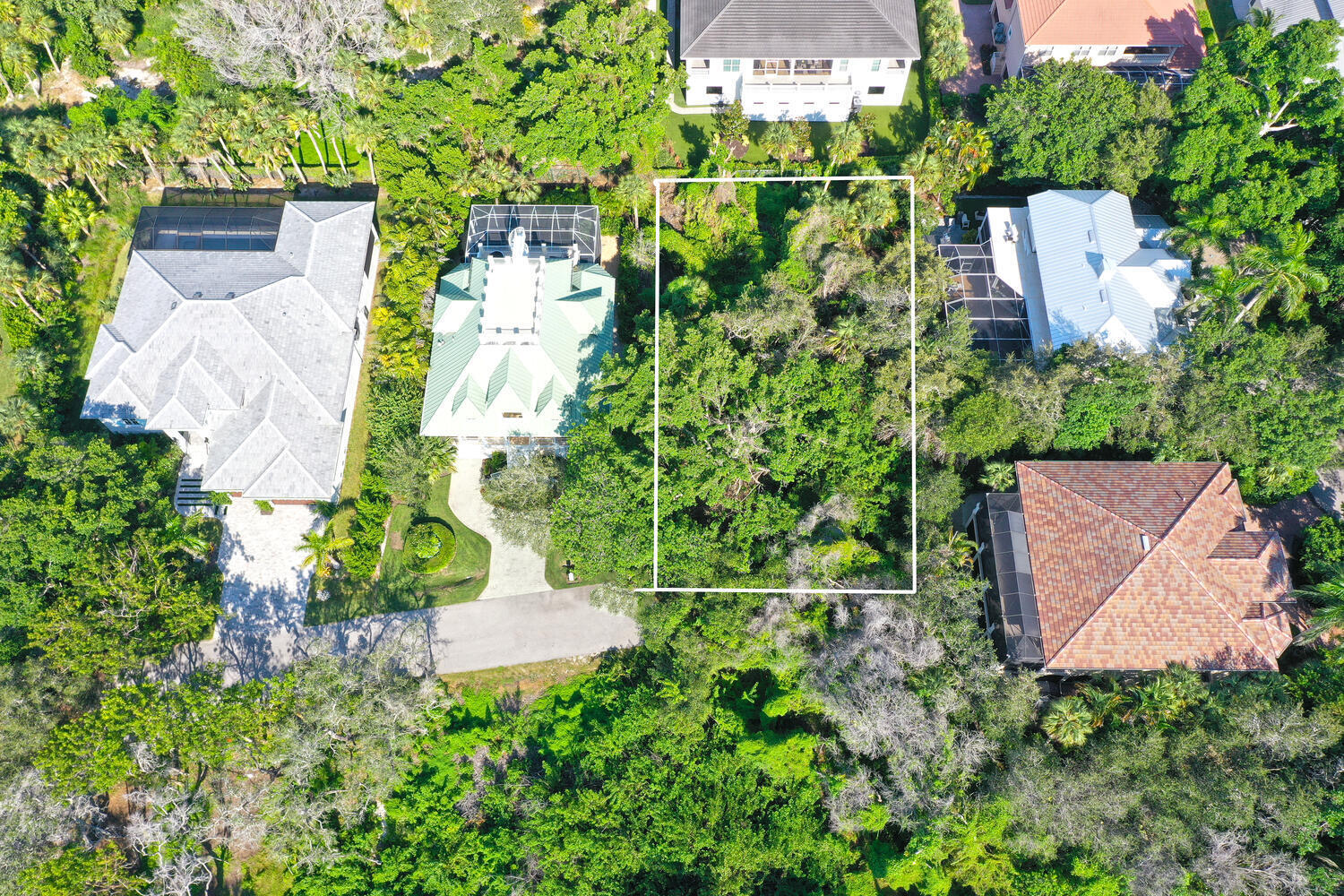 an aerial view of a house with a yard and fountain