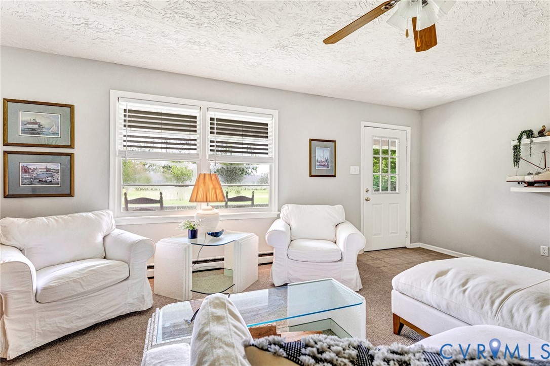 635 River Oaks Road Center Cross, VA 22437 - Photo 16 of 63 Living area with two large windows and a glass-pan