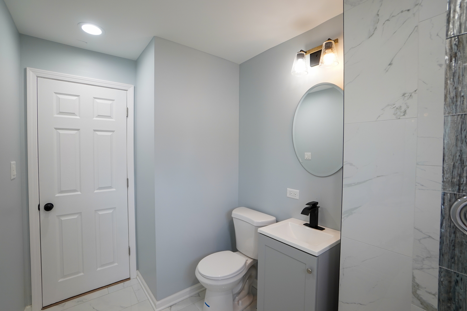 646 Frances Street Phoenix, IL 60426 - Photo 11 of 30 a bathroom with a toilet a sink and a mirror