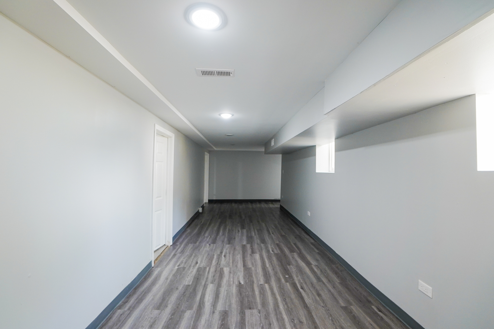 646 Frances Street Phoenix, IL 60426 - Photo 12 of 30 an empty room with wooden floor