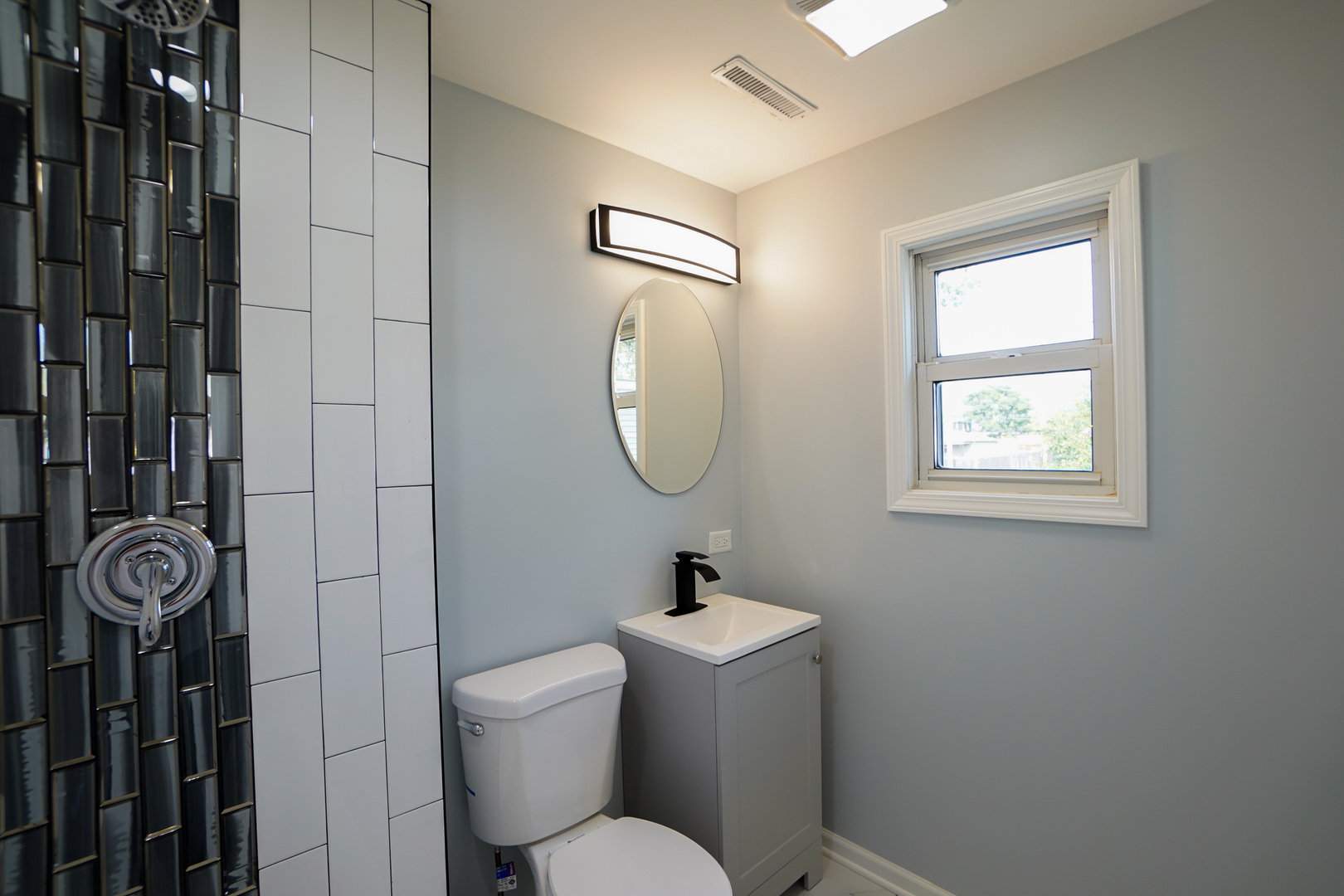 646 Frances Street Phoenix, IL 60426 - Photo 17 of 30 a bathroom with a toilet a sink and mirror