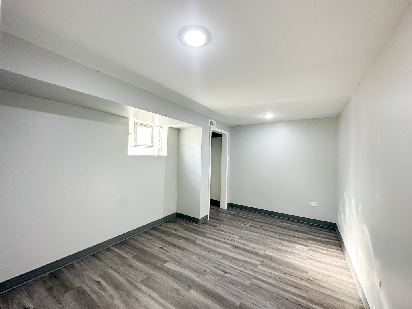 646 Frances Street Phoenix, IL 60426 - Photo 19 of 30 wooden floor in an empty room with a window