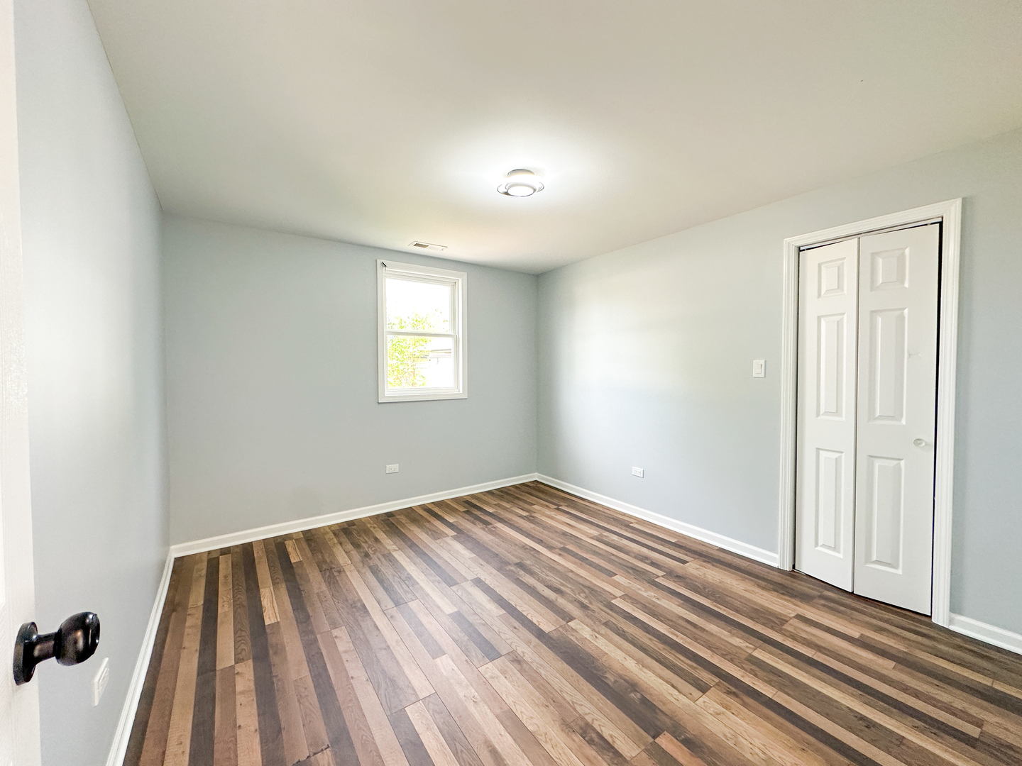 646 Frances Street Phoenix, IL 60426 - Photo 28 of 30 a view of an empty room with wooden floor and a window