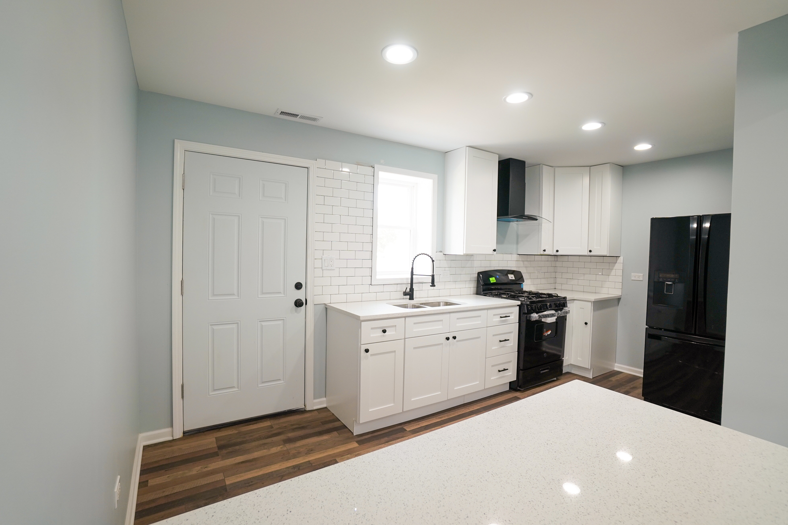 646 Frances Street Phoenix, IL 60426 - Photo 3 of 30 a kitchen with a refrigerator and white cabinets