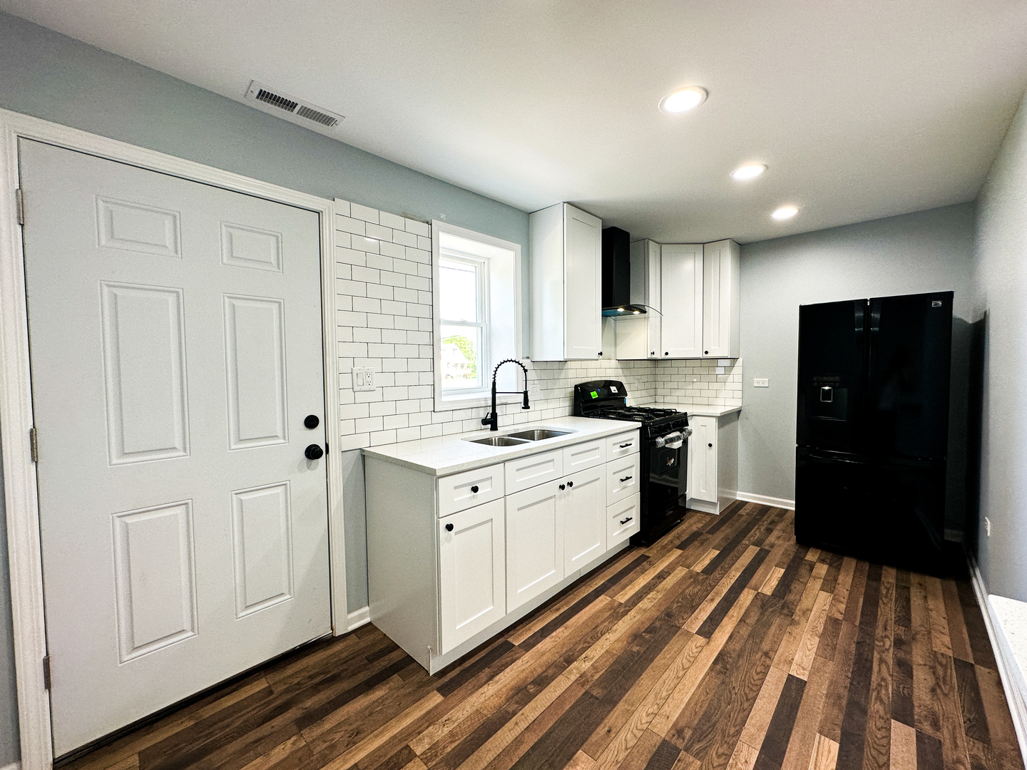 646 Frances Street Phoenix, IL 60426 - Photo 5 of 30 a kitchen with granite countertop white cabinets and refrigerator