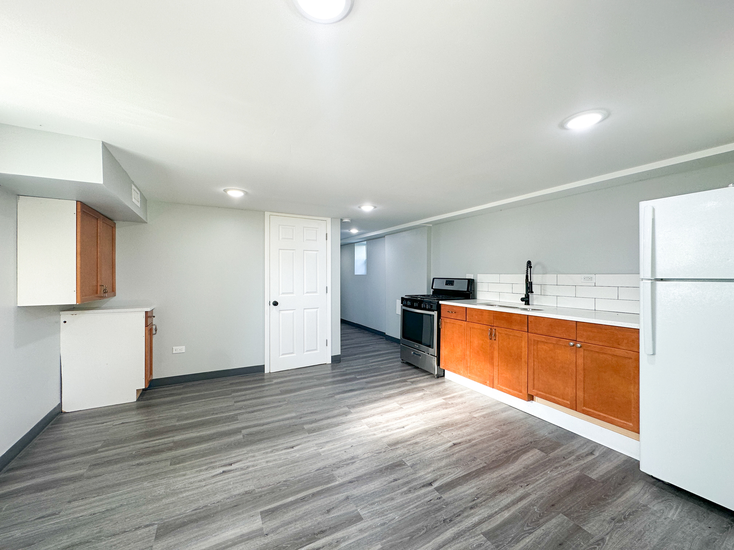 646 Frances Street Phoenix, IL 60426 - Photo 8 of 30 a large kitchen with wooden floors and stainless steel appliances