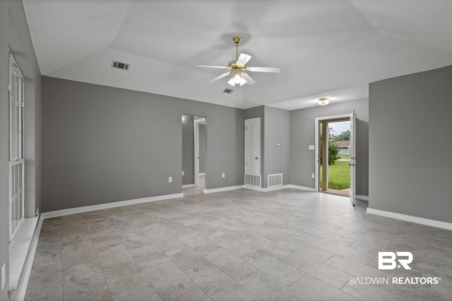 16418 Avent Lane Foley, AL 36535 - Photo 11 of 30 Spare room featuring ceiling fan and a textured ceiling