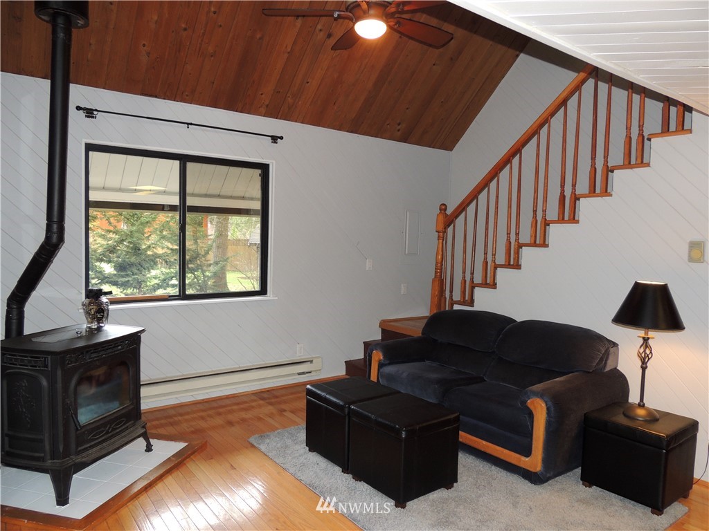 17609 Loop Lane Southeast Yelm, WA 98597 - Photo 2 of 23 a living room with furniture with wooden floor and windows