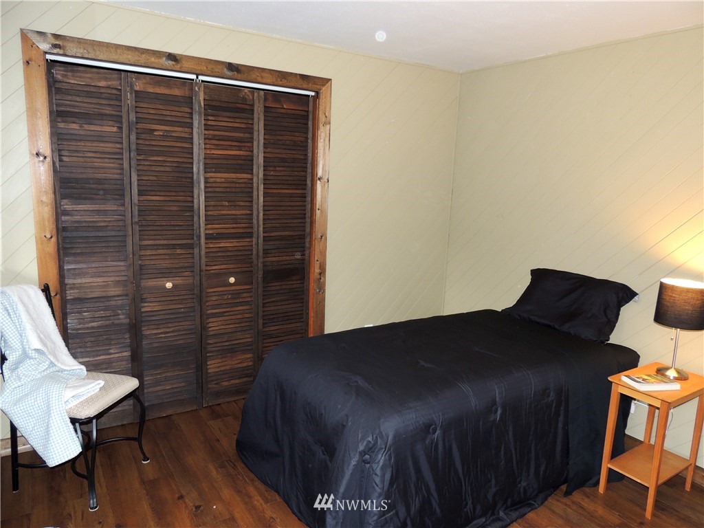 17609 Loop Lane Southeast Yelm, WA 98597 - Photo 12 of 23 a bedroom with a bed and wooden floor