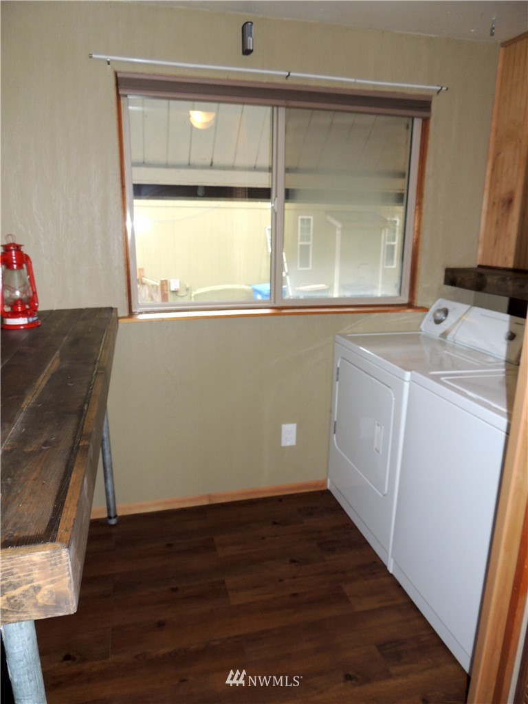 17609 Loop Lane Southeast Yelm, WA 98597 - Photo 18 of 23 a view of a kitchen with wooden floor and electronic appliances