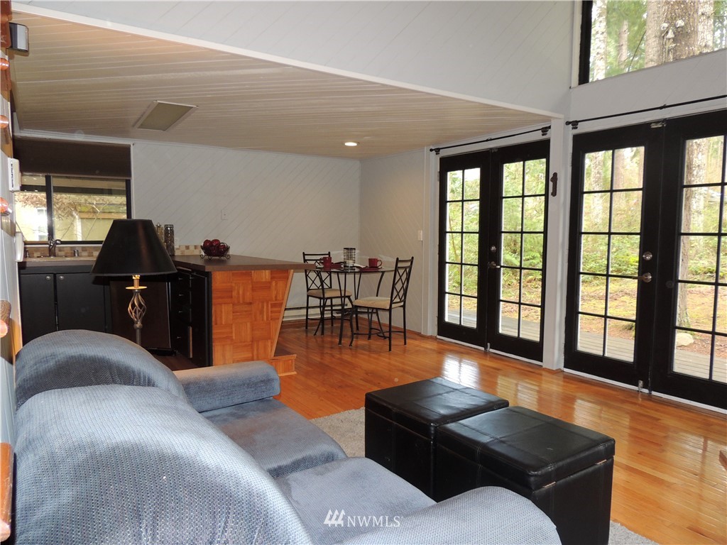 17609 Loop Lane Southeast Yelm, WA 98597 - Photo 4 of 23 a living room with furniture and floor to ceiling windows