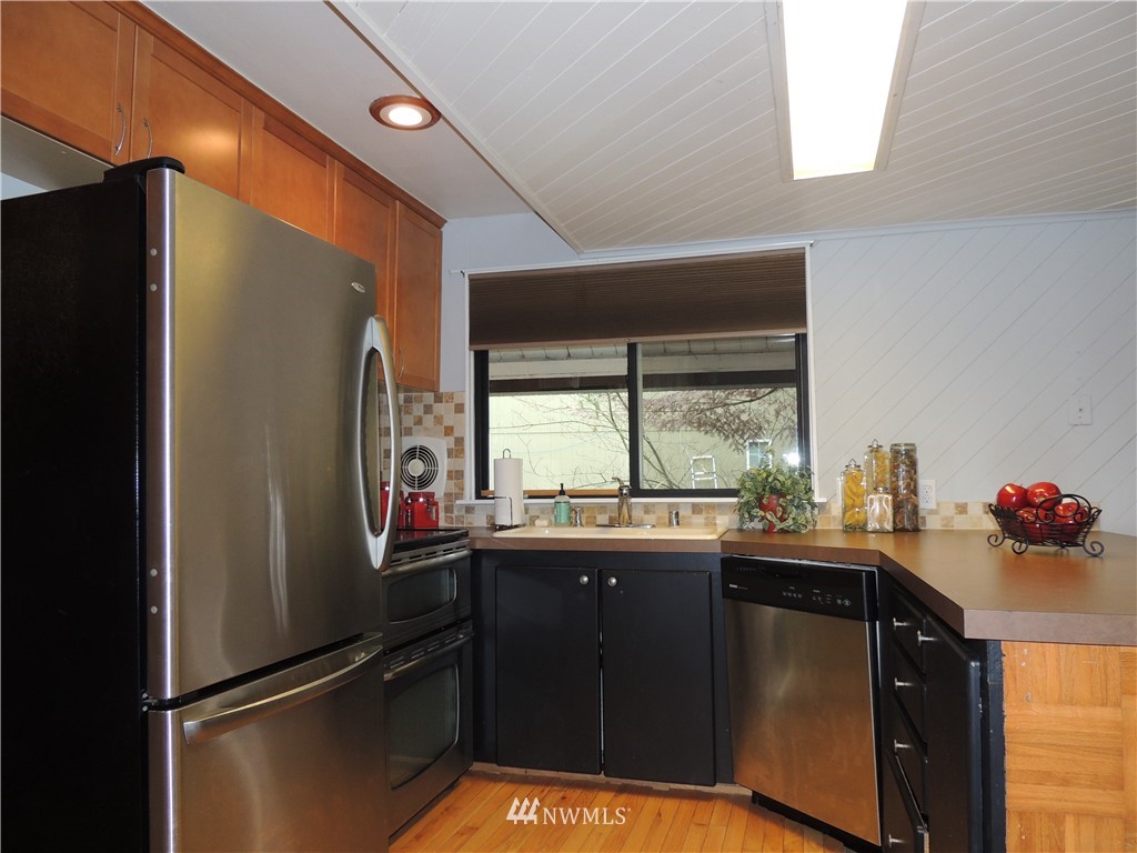 17609 Loop Lane Southeast Yelm, WA 98597 - Photo 6 of 23 a kitchen with a sink a refrigerator and window