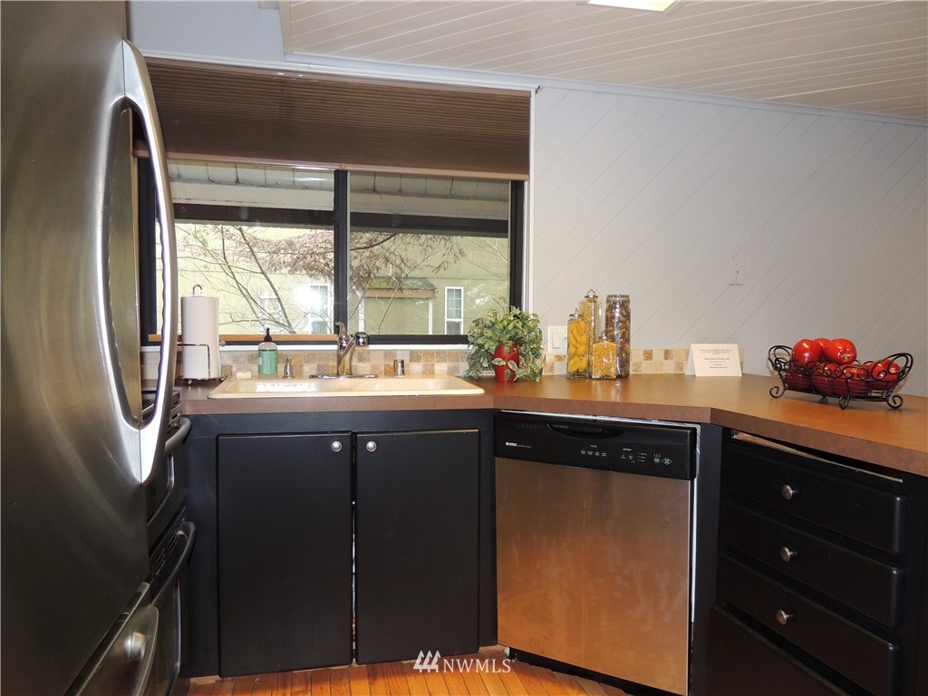17609 Loop Lane Southeast Yelm, WA 98597 - Photo 7 of 23 a kitchen with a sink a window and cabinets