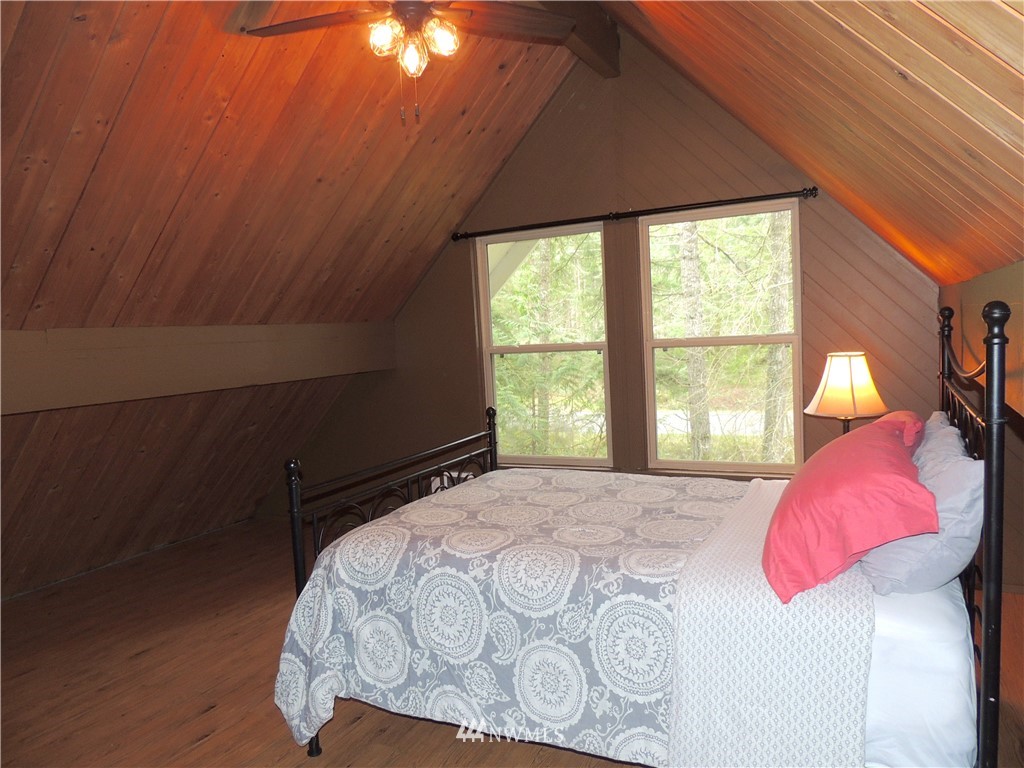 17609 Loop Lane Southeast Yelm, WA 98597 - Photo 9 of 23 a bedroom with a bed and a window