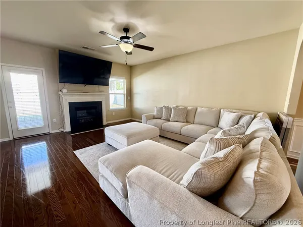 a living room with furniture and a fireplace